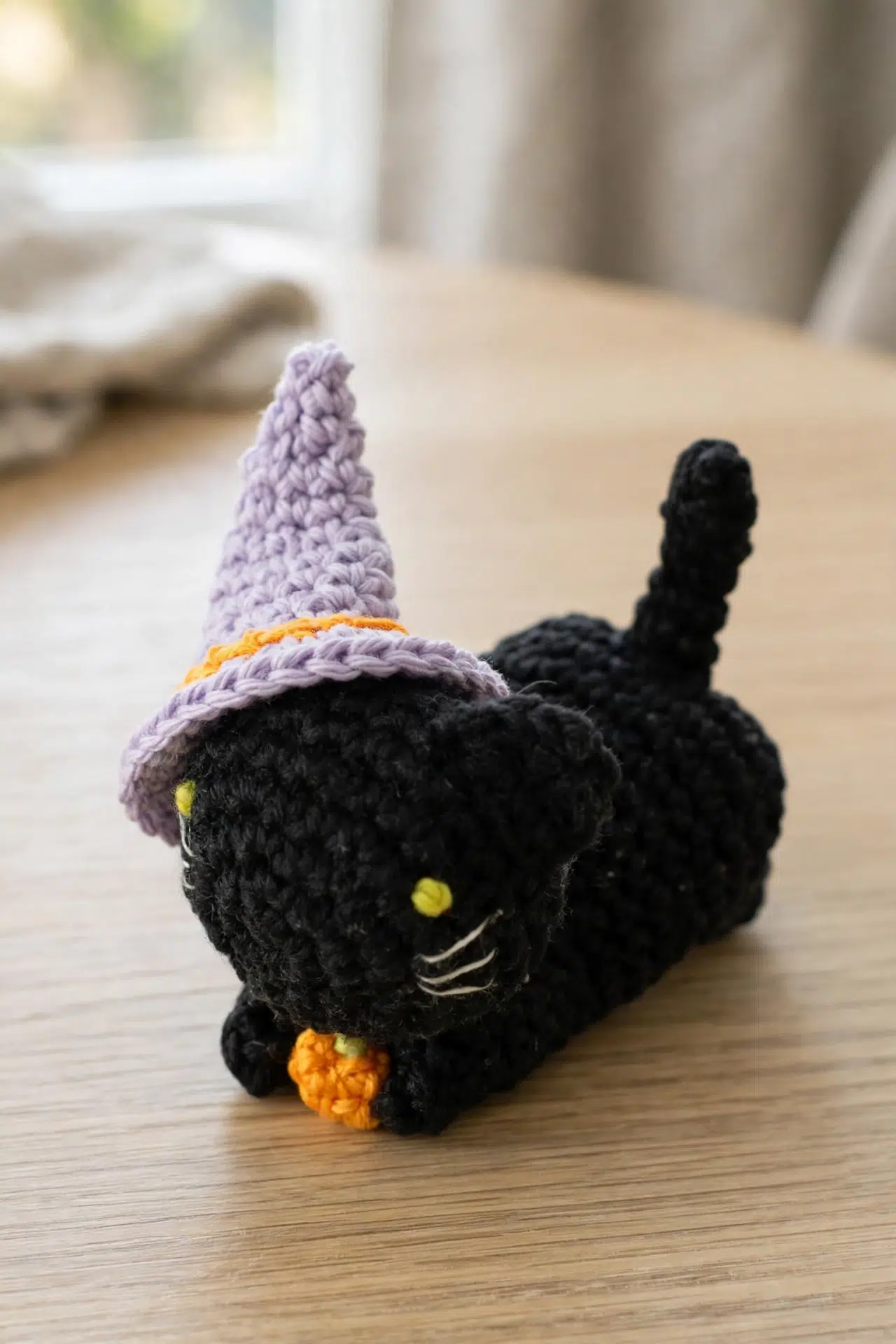 Close-up angle of Crochet Witch Cat Amigurumi showing textured stitches and facial details