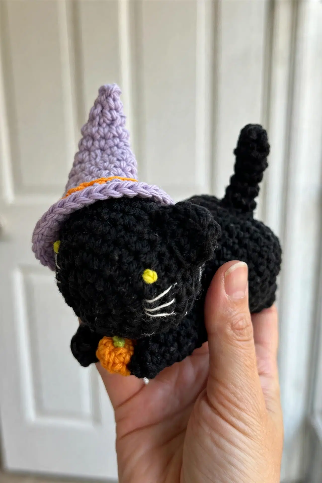 Crochet Witch Cat Amigurumi styled as a charming handmade Halloween decoration