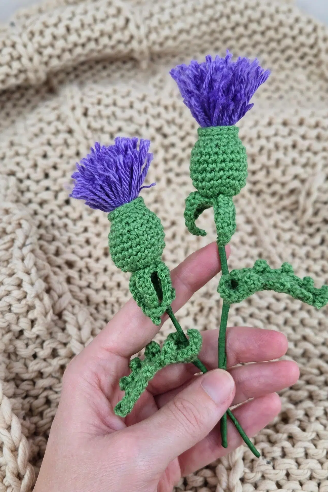 Purple Crochet Thistle Flower displayed as a finished floral decoration in a setting