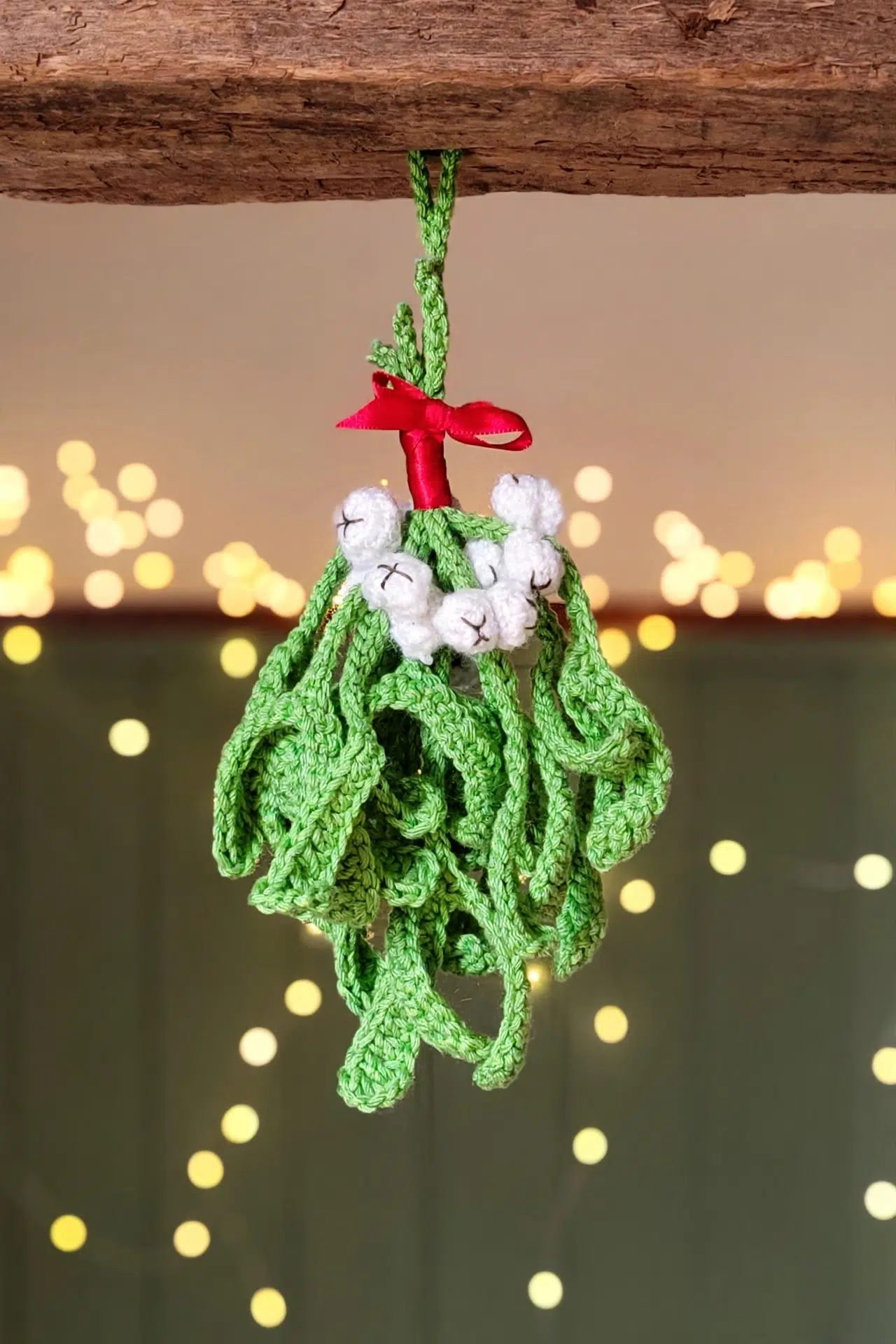 Festive Crochet Mistletoe displayed as charming seasonal decor with textured green leaves
